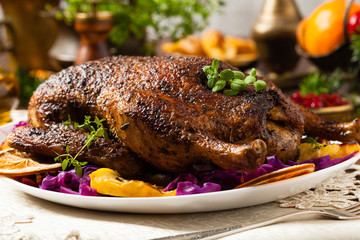 Baked whole duck, served with apples, red cabbage, oranges and roasted fritters.
