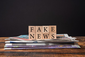 Fake news concept on black background