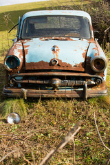 Old, rusty car wreck front and lamp outdoor