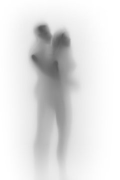 Diffuse body silhouette of a lover couple together behind a white curtain or glass surface.