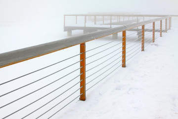 Park pier in the frost and snow