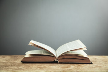 Open book on wooden table. Education concept