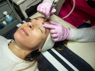 A woman during oxygen infusion treatment at beauty salon.
