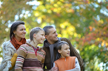 Fototapeta premium Family of four walking in autumn park