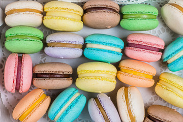 Cake macaron or macaroon on gray background from above. Colorful almond cookies, bright colors. Top view, flat lay