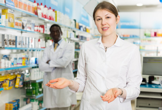 woman pharmacist inviting to drugstore