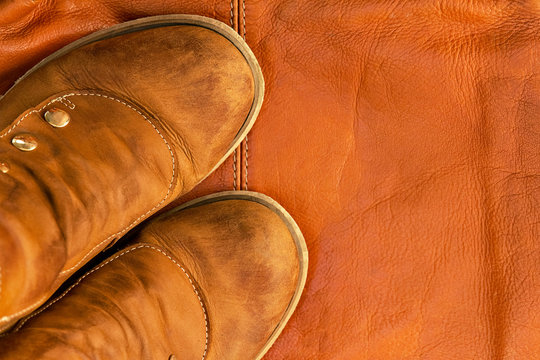 Brown Leather Shoes On Yellow Brown Background Of Same Bag