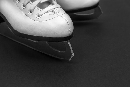 White Leather  Figure Skates On A Dark Background