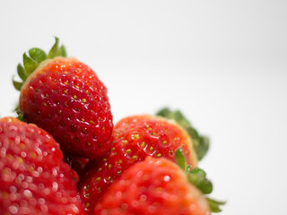 Fresh strawberries on white background cropped with space to right