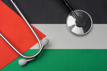 Palestinian flag and stethoscope. The concept of medicine.