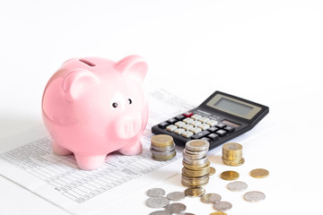 piggy bank with coins and calculator