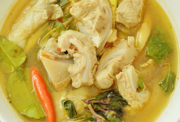 hot and spicy pork bone with tamarind and Thai herbs soup on glass bowl