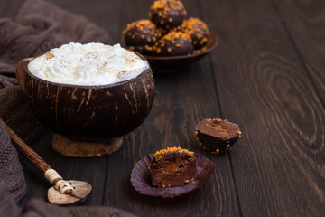 A cup of black coffee with chocolate truffles. Homemade fresh truffle dark chocolate candies with a cup of coffee. Copy space.