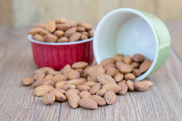 Almond nut on wood background.