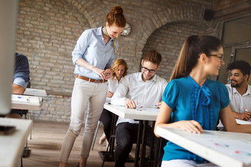 Successful happy group of people learning software engineering and business during presentation
