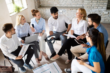 Startup business team on meeting in modern bright office interior brainstorming, working on computer