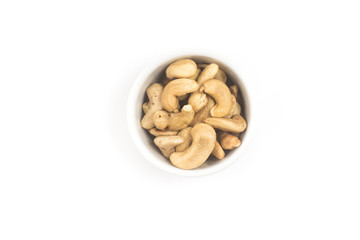 Cashew nuts in a small bowl. Top view