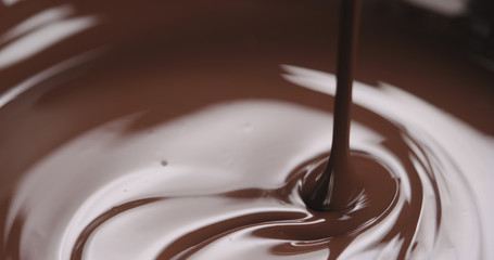 closeup pouring molten dark chocolate