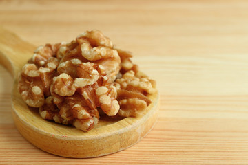 Pile of Walnut Kernels on Wooden Spoon on Wooden Table with Free Space for Text or Design  