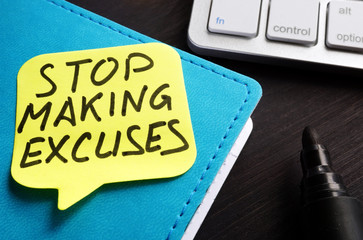 Stop making excuses written on a piece of paper.