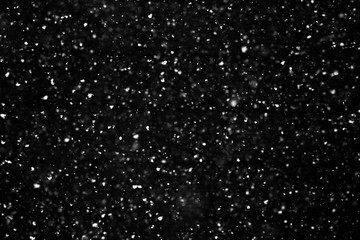 Snow falling isolated on black 