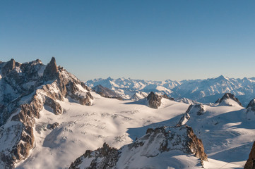 View over the French Alps, from the Aiguille du Midi cable on a winter afternoon, just before Christmas.