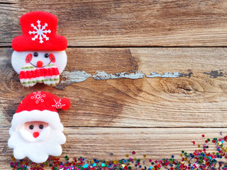 Christmas background decorations with Snowman and gift boxes on the old wood board by Flat lay, top view and copy space. In concept, happy with the holidays in the new year.