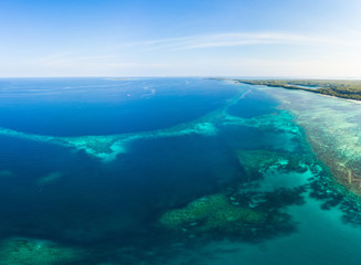 Fototapeta na wymiar Aerial view coral reef scattered in caribbean sea, tropical beach islands. Indonesia Moluccas archipelago, Kei Islands, Banda Sea. Top travel destination, best diving snorkeling, stunning panorama.