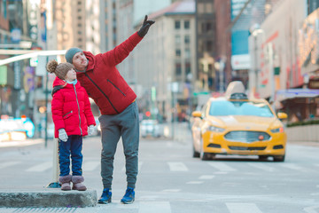 Family of father and little kid on Times Square during their vacation in New York City