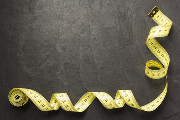 tape measure on slate stone background