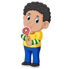 Curly boy licking a lollipop