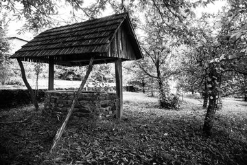 Abandoned well in the forest. Waiting for a terrible girl with a long hair. Halloween concept. Selective focus