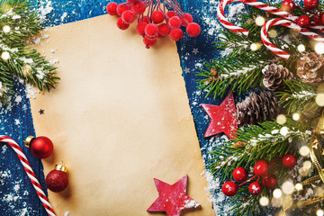 Merry Christmas holiday card or banner with snowy fir branches, cones and festive decorations. Magic bokeh lights.