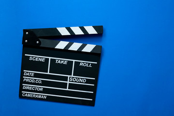 Fototapeta na wymiar movie clapper on blue background ; film, cinema and video photography concept