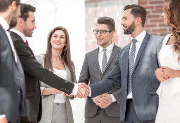 business team looks at the handshake of business partners