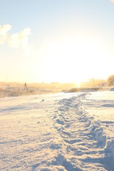 Fototapeta na wymiar snowy path and sunset