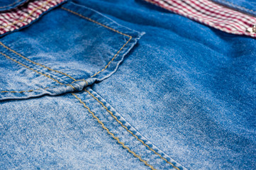 Blue washed faded jeans texture with seams, clasps, buttons and rivets