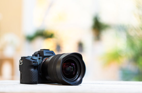 Professional digital SLR camera on a bright interior room background