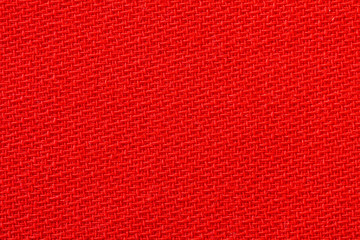 Red fabric background texture. Detail of textile material close-up