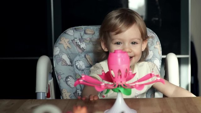 Little cute girl blowing out candles for her birthday and smiling