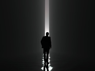 businessman walking towards the light