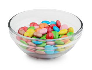 Multicolor candies in glass bowl isolated on white