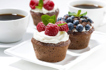 sweet chocolate cupcakes with fresh berries for dessert