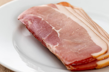 Close up of raw ham on a white plate