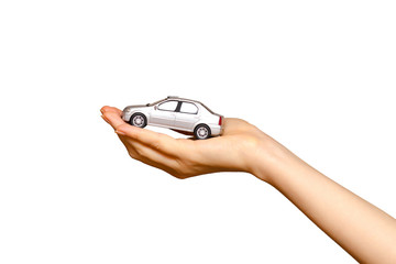 Female hand holding a grey toy car, isolated on white