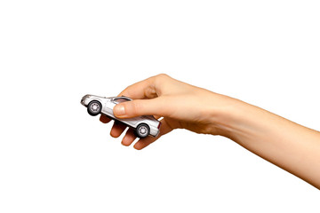 Female hand holding a grey toy car, isolated on white