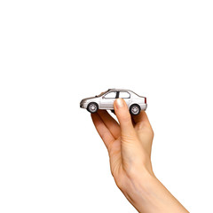 Female hand holding a grey toy car, isolated on white