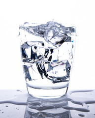 Glass of water with ice cubes isolated on white background