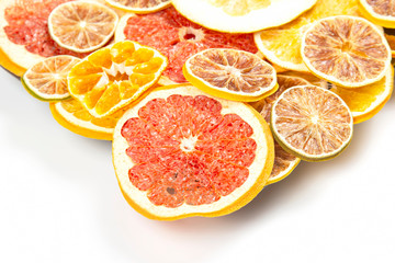 Dried slices of various citrus fruits on white background