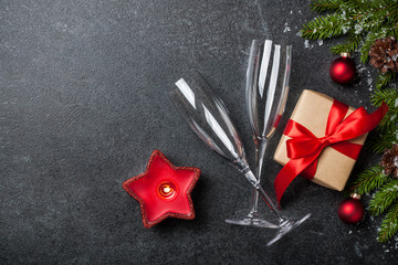 Christmas and New Year background with gift box, champagne glasses and decorations